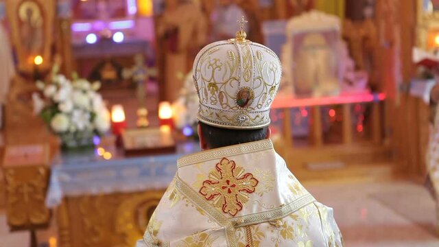The church bishop sits in the church during prayer. Pontifical Solemn Mass.
