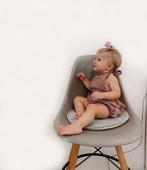 baby girl sitting on a chair