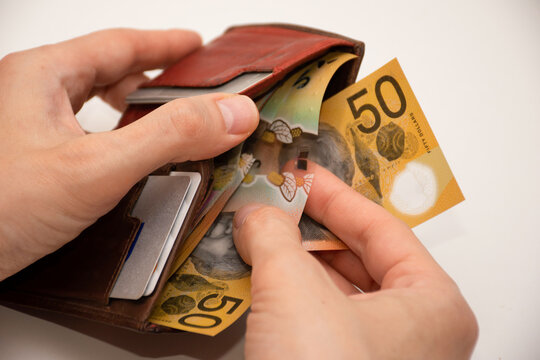 Hands holding leather wallet with australian dollars 50 banknotes. Finance and payment concept.