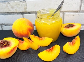 Glass jar of fresh delicious homemade jam made from ripe juicy peaches. The concept of proper nutrition, agriculture.