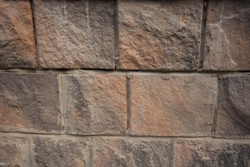 Big brown stone in the wall background 