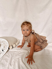 little girl sitting on the bed