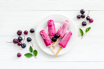 Cherry ice cream, berry popsicles on the table, top view