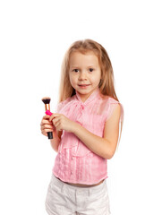 girl with lip gloss and makeup brush in her hands