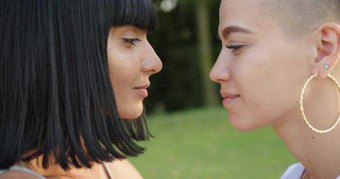 Beautiful lesbian brunette woman kissing her girlfriend in the nose