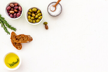 Italian olives, oil, bread - appetizer and snacks - top view copy space