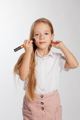  girl does makeup using a powder brush