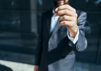 A business man outdoors holds the hand of an official close-up