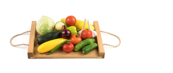 Fresh fruit:tomatoes, cucumbers, zucchini, peppers and cabbage on a white background on a wooden tray. Trading platform. Top view, panorama. The concept of natural products, proper nutrition.