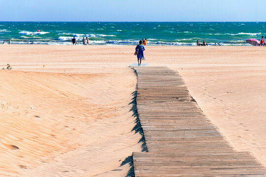 Wooden walkway in the sand on a Spanish beach to access the Atlantic Ocean