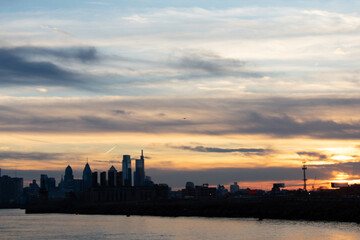 Fototapeta na wymiar A View of the Philadelphia Skyline Over Water on a Dramatic Sunset
