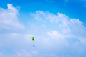 Athlete practicing paragliding alone in the cloudy sky of southern Spain