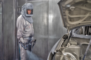 employee body painting workshop carries out painting of the internal elements of the car.