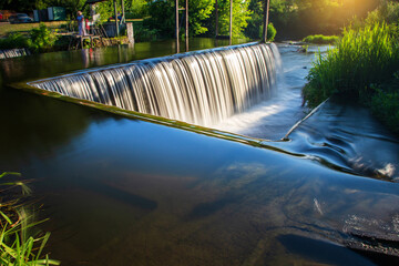 A beautiful artificial waterfall for swimming in the summer in the city of Satanov..
