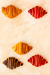 Set of croissants - chocolate, berry, classic - on stone table top view