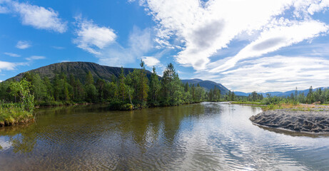 Obraz premium Panorama with a lake against the background of the mountain range and forest of the Khibiny mountains