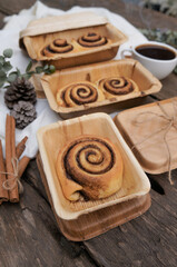 Cinnamon rolls on a plate from nature on a wooden table.