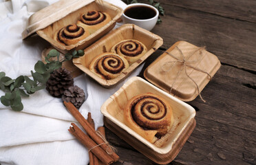 Cinnamon rolls on a plate from nature on a wooden table.
