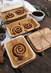 Cinnamon rolls on a plate from nature on a wooden table.