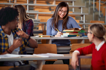 Female student with colleagues in amphitheater
