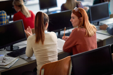 Two girls in classroom, back view