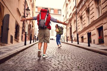 Fototapeta na wymiar Young tourist couple walking an old street