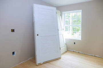 Interior wooden stacker door installation apartment building, wait installation for preparation of interior in new home