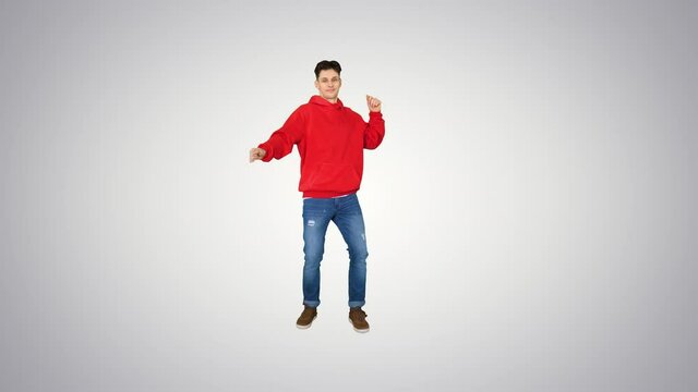Hip-Hop style man in red hoody dancing on gradient background.