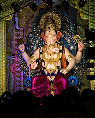 Closeup, portrait view of decorated and garlanded idol of Hindu God Ganesha.