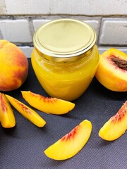 Glass jar of fresh delicious homemade jam made from ripe juicy peaches. The concept of proper nutrition, agriculture.