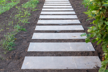 Step path made of concrete slabs in the Park. Step-by-step concrete path
