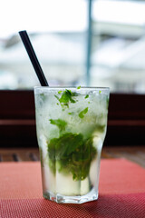 Fresh mojito cocktail on the table in the bar. Cool tropical cocktail.