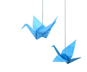Origami paper cranes haning isolated white