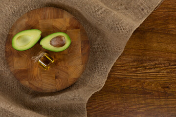 View of an avocado and olive oil bottle on wood table background