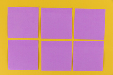 View of six purple sheets of paper in one size on a plain yellow background