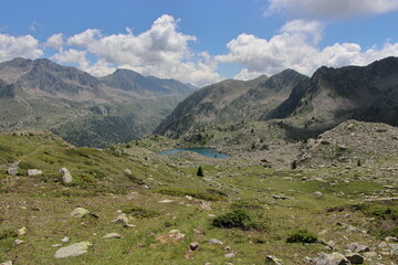 Fototapeta na wymiar Jaw-droppingly beautiful mountains and lakes in Sant'Anna di Vinadio on a partly cloudy day.