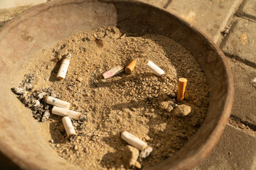 smoked cigarettes in a bowl with Sand 