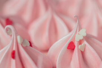 Close-up small pink meringues on a pink background. Handmade. Celebration.