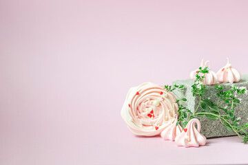 Pink meringues close-up on a creative stone podium on a pink background. Handmade meringue. Contemporary still life.