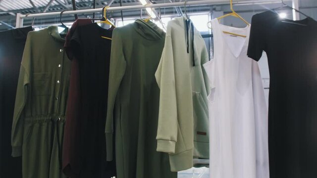 Clothing production - examples of dresses hang on hangers