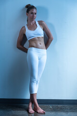 Fototapeta premium Young urban athlete in exercise gear warming up and stretching.