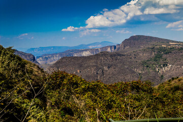Huentitan canyon with its mountains and great vegetation with a spectacular blue sky and white clouds on a sunny day in Guadalajara, Jalisco Mexico