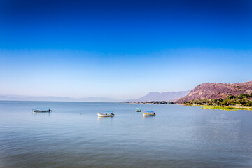 Motorboats on the lake of Chapala with a blue sky on a wonderful and sunny day in the state of Jalisco Mexico