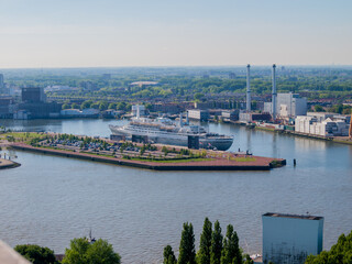 Aerial view of the Maas (Meuse) river with a cruise hotel anchored in the quay of the port of the...