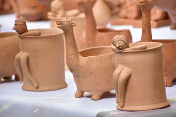 Lot of clay pot in a local pottery craft shop on small street. - obrazy, fototapety, plakaty