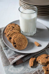 Tasty cookies and glass of milk on rustic wooden background