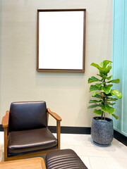 Day light, Living room with blank white picture frame and Fiddle Fig tree,copy space.