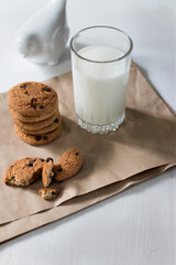 Tasty cookies and glass of milk on rustic wooden background