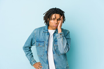 Young black man wearing a jeans jacket who is bored, fatigued and need a relax day.