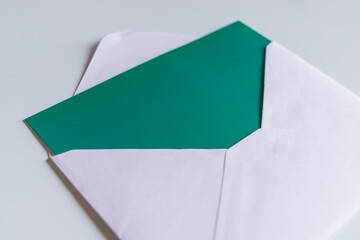 Green blank card inside white envelope.